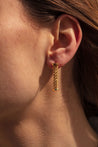 Photo porté des boucles d'oreille Adelia en maille or 18 carats